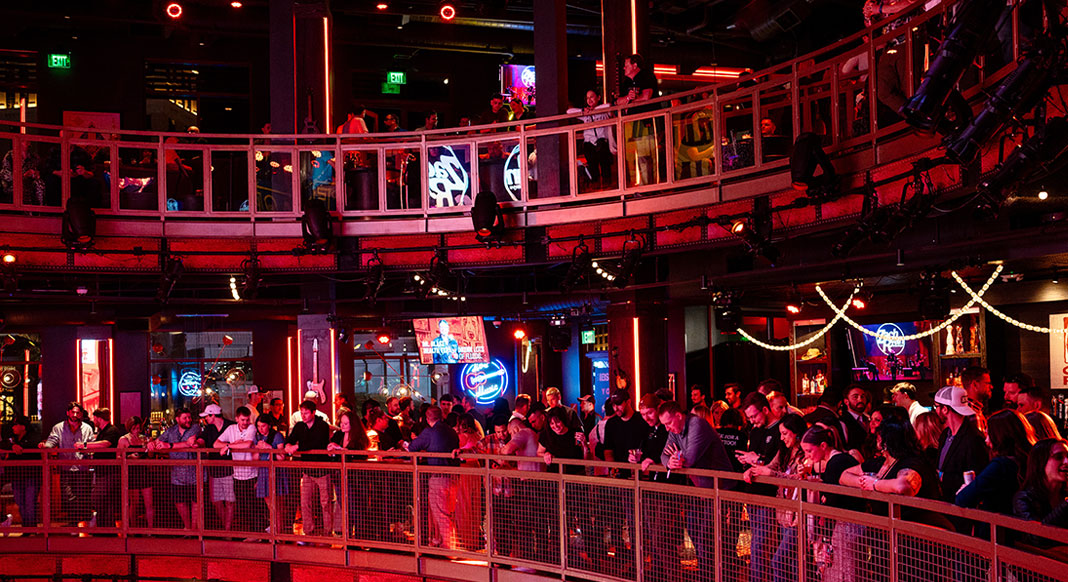 2025 Young Pro Party people standing on two levels of the venue